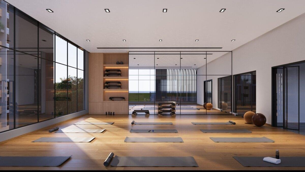 "Spacious and well-lit aerobics and yoga room with wooden flooring at Gamya by Supadha."