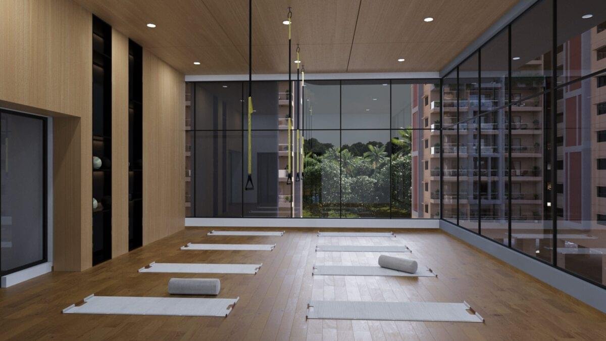 "Spacious and well-lit yoga room with wooden flooring at Gamya by Supadha."